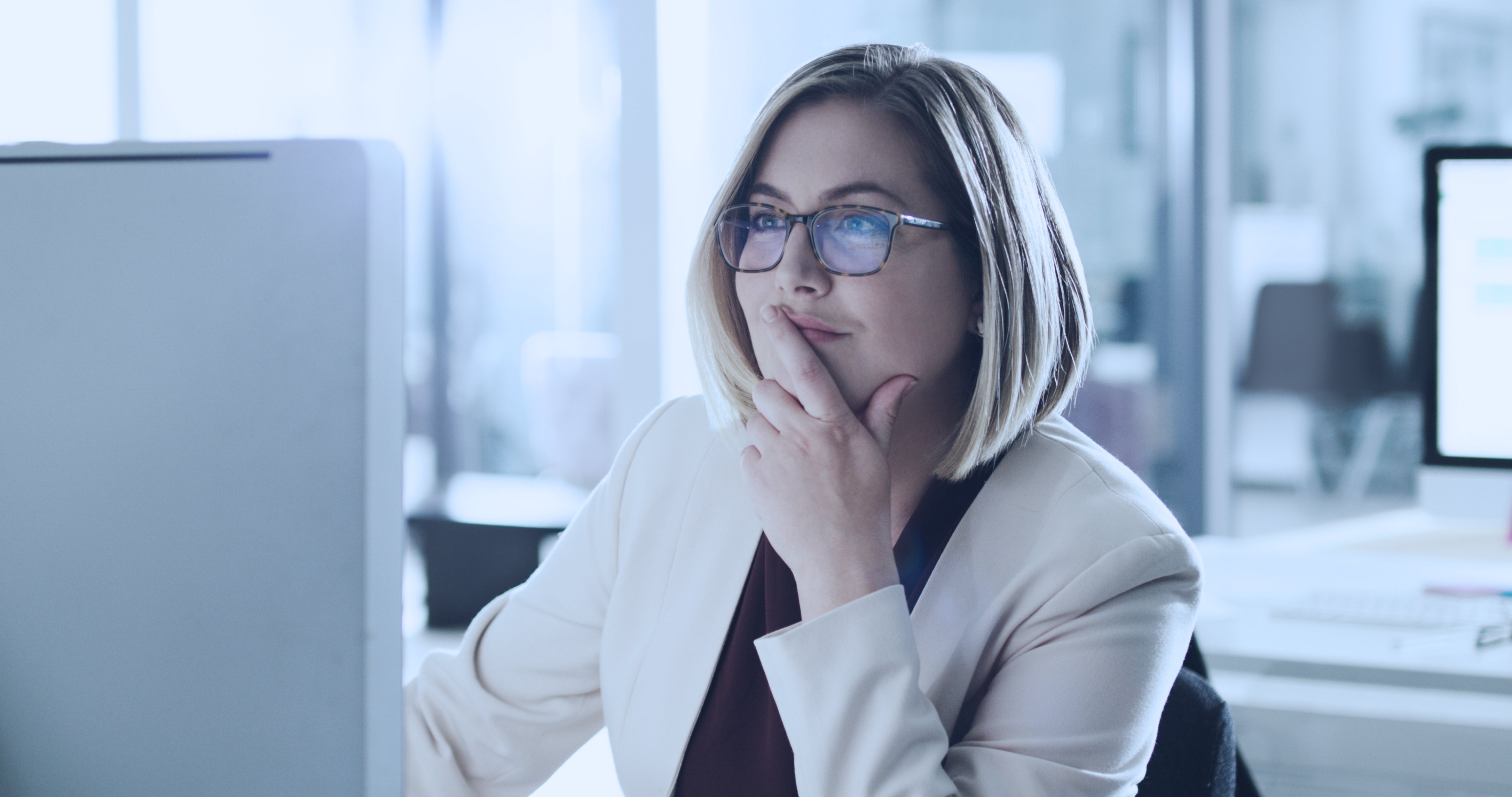 Woman using computer, highlighting secure public cloud utilization for multiple IT business applications and services