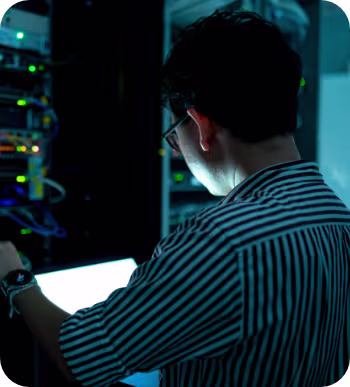 A green shield in a data center, representing cybersecurity and the safeguarding of critical information systems
