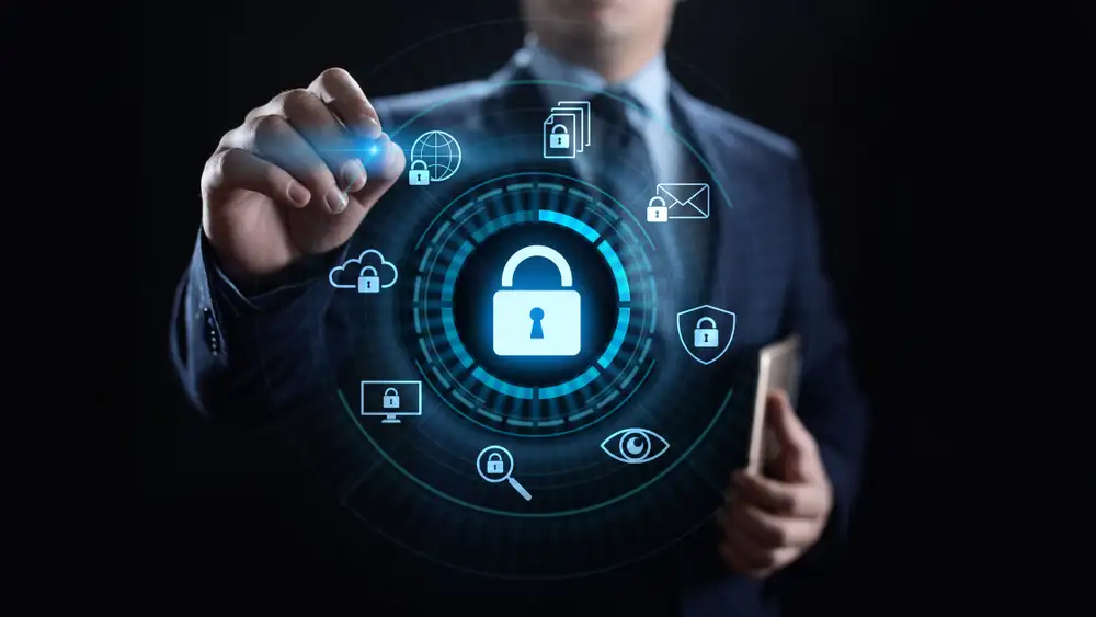 Businessman with a padlock and screen icons, highlighting the importance of cyber security solutions for digital safety