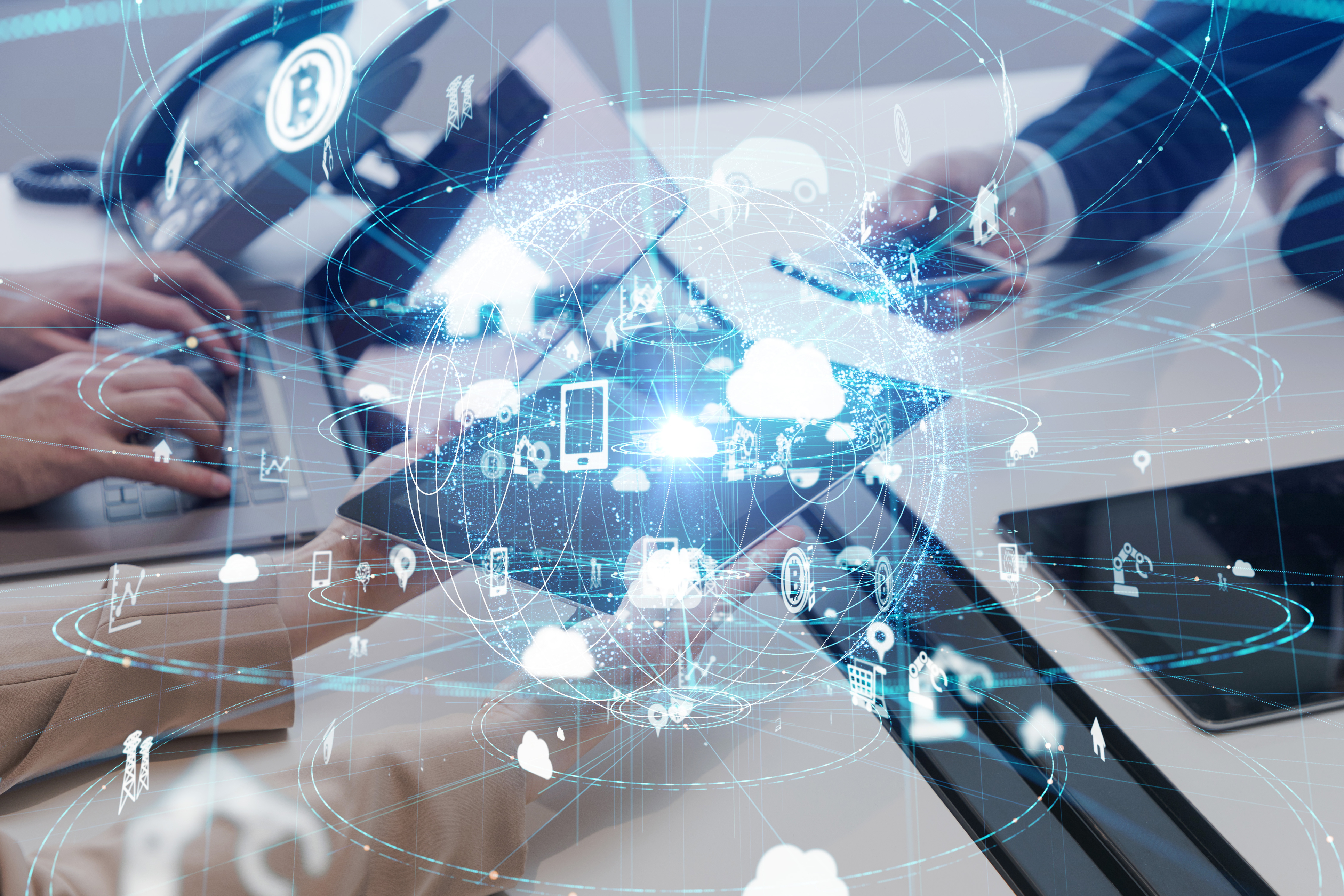 IT Systems Project Management and Installation Services Business professionals collaborating on laptop, displaying various icons on their screens, symbolizing teamwork and technology